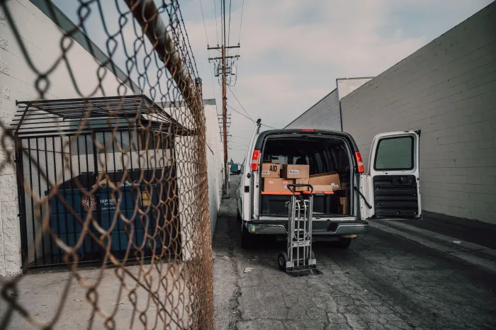 A junk removal crew loading furniture and boxes onto a truck
