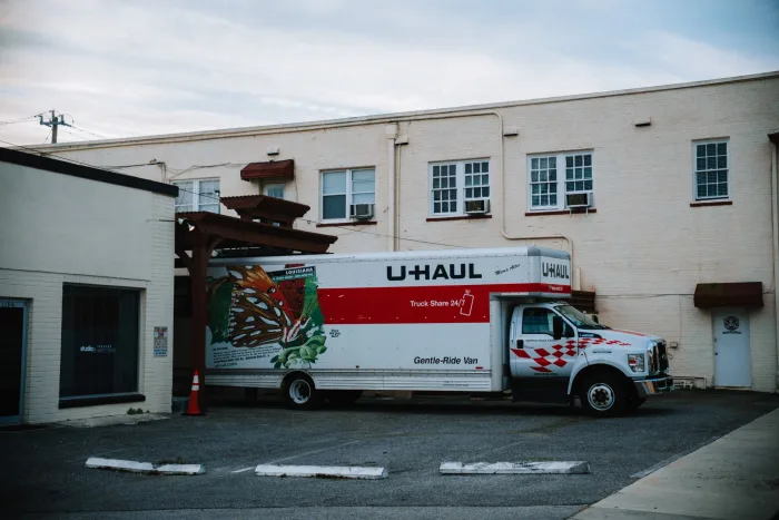 A junk removal truck loaded with furniture and boxes